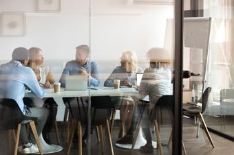 Team discussing Management Information in a boardroom